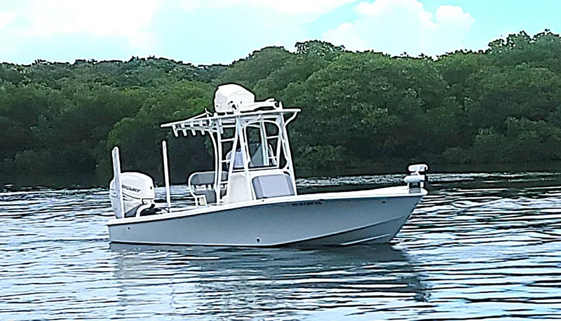 Slide: The Image of 2017 SeaVee 270Z boat on calm water with lush green background. - 2