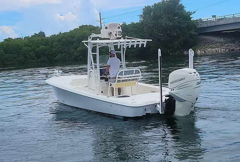 Slide: The Image of 2017 SeaVee 270Z boat on water, featuring Mercury engine, near bridge and trees. - 24