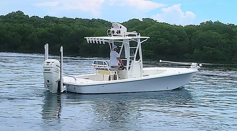 Slide: The Image of 2017 SeaVee 270Z boat on calm water, surrounded by lush greenery. - 26