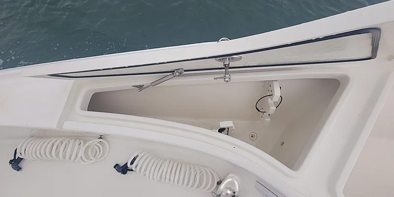 Slide: The Image of 2017 SeaVee 270Z boat storage compartment with coiled ropes, open hatch, and ocean background. - 7