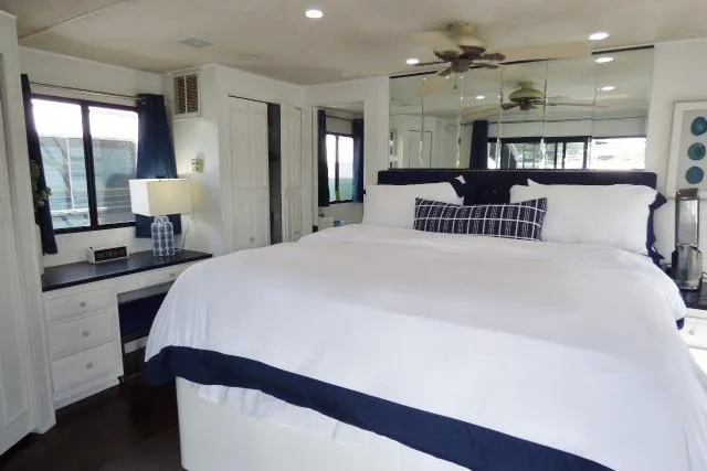 Slide: The Image of Luxurious bedroom in a 1997 Sumerset 16x80 houseboat with elegant decor and ample natural light. - 10