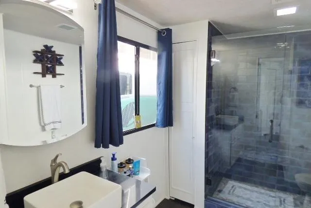 Slide: The Image of Bathroom in 1997 Sumerset 16x80 houseboat with modern sink and glass shower. - 11