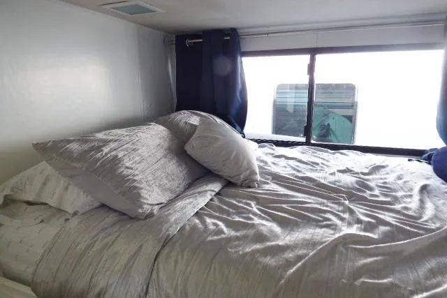 Slide: The Image of Cozy bedroom with gray bedding in a 1997 Sumerset 16x80 houseboat. - 6
