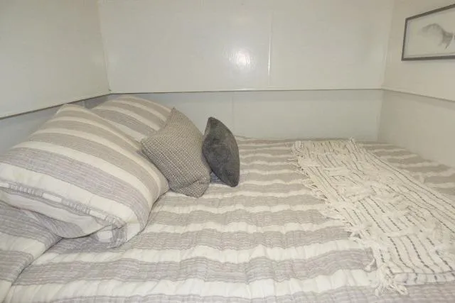 Slide: The Image of Cozy bedroom with striped bedding in a 1997 Sumerset 16x80 houseboat. - 8