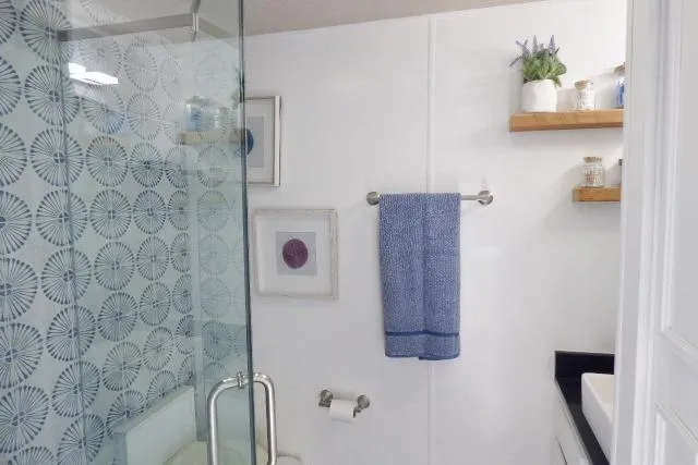 Slide: The Image of Modern bathroom in 1997 Sumerset 16x80 houseboat with glass shower and blue accents. - 9