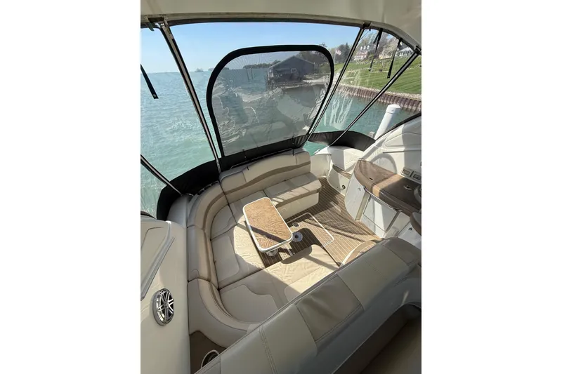 Slide: The Image of 2014 Formula 37 Performance Cruiser interior with seating and table, overlooking serene waterfront. - 11