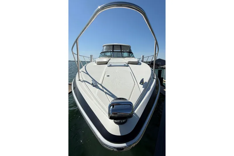 Slide: The Image of 2014 Formula 37 Performance Cruiser docked, showcasing sleek design and spacious deck. - 2