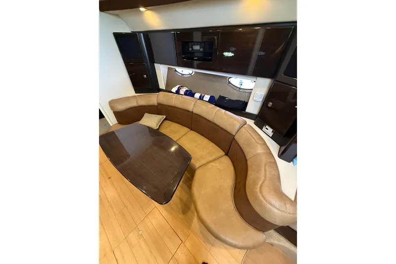 Slide: The Image of Luxurious interior of a 2014 Formula 37 Performance Cruiser with curved seating and wooden table. - 26