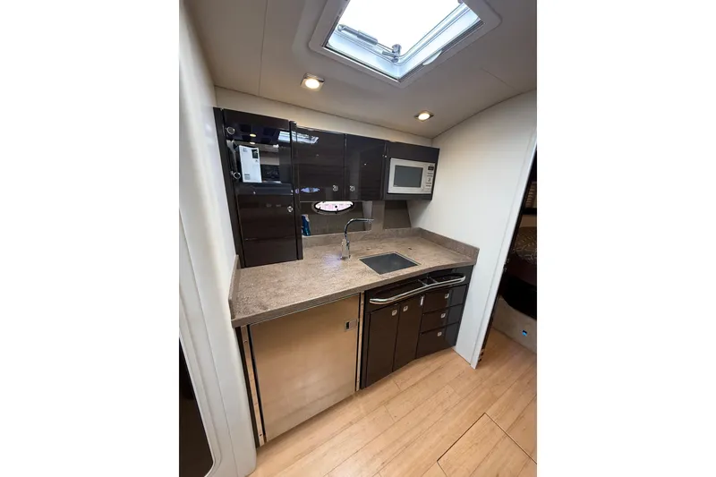 Slide: The Image of 2014 Formula 37 Performance Cruiser kitchen with modern appliances and sleek cabinetry. - 27