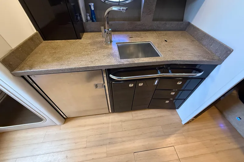 Slide: The Image of Modern kitchenette in a 2014 Formula 37 Performance Cruiser with sleek countertop and stainless steel sink. - 28