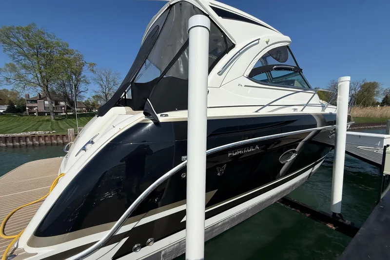 Slide: The Image of 2014 Formula 37 Performance Cruiser docked at marina under clear blue sky. - 6