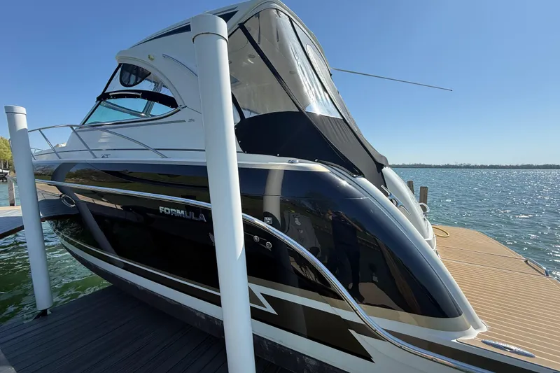 Slide: The Image of 2014 Formula 37 Performance Cruiser docked by the water on a sunny day. - 7
