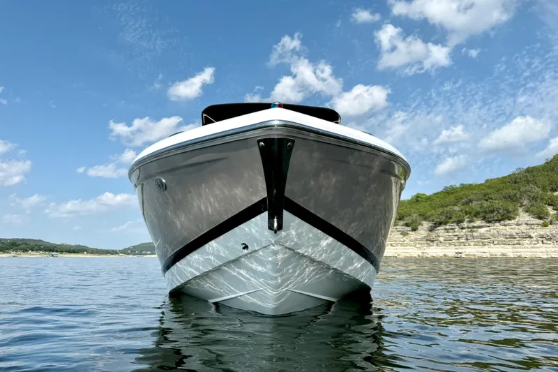 Slide: The Image of 2013 Cobalt A25 boat on calm water with scenic background. - 11