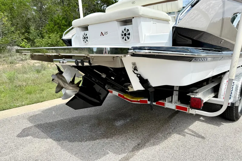 Slide: The Image of 2013 Cobalt A25 boat rear view with propeller and trailer. - 15