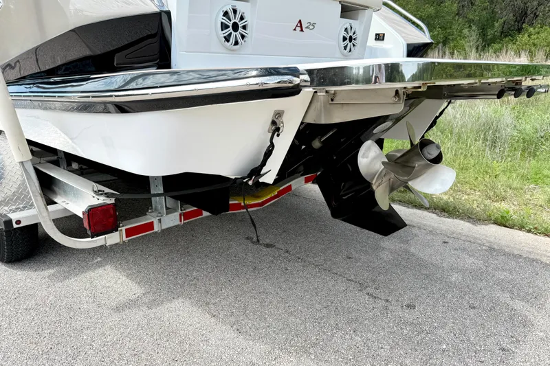 Slide: The Image of Rear view of a 2013 Cobalt A25 boat on a trailer, showing propeller and speakers. - 19