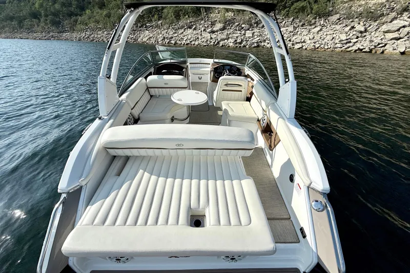Slide: The Image of Luxurious 2013 Cobalt A25 boat interior with white seating on a serene lake. - 20