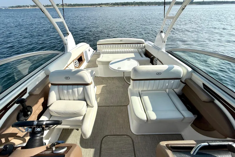 Slide: The Image of 2013 Cobalt A25 boat interior with luxurious white seating on open water. - 22