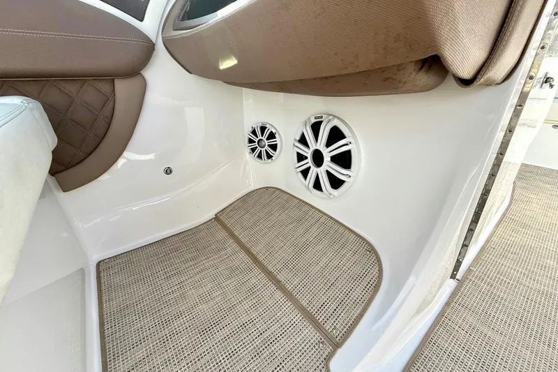 Slide: The Image of Interior of a 2013 Cobalt A25 boat featuring speakers and cushioned seating. - 27