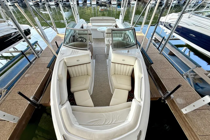 Slide: The Image of 2013 Cobalt A25 boat docked, featuring spacious seating and sleek design. - 28