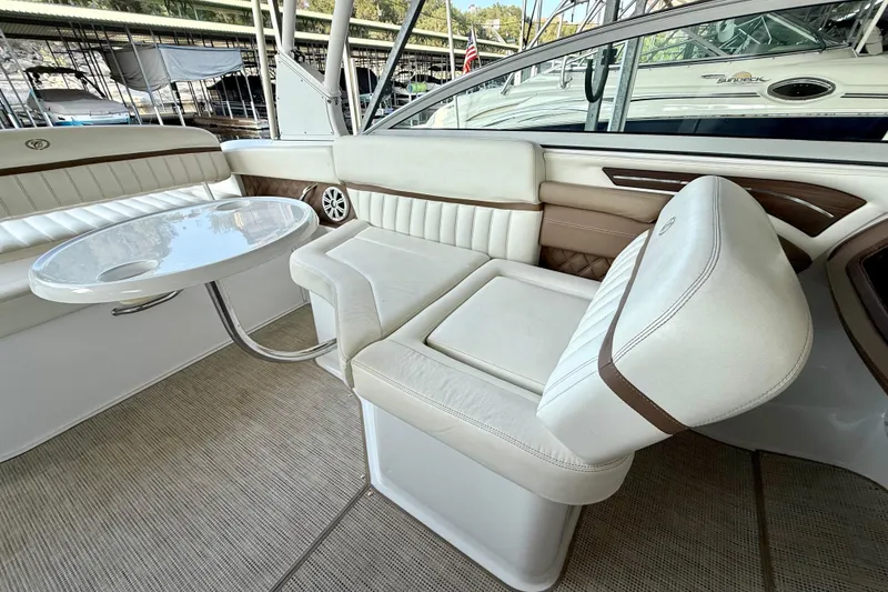 Slide: The Image of Luxurious interior of a 2013 Cobalt A25 boat with white seating and table. - 29