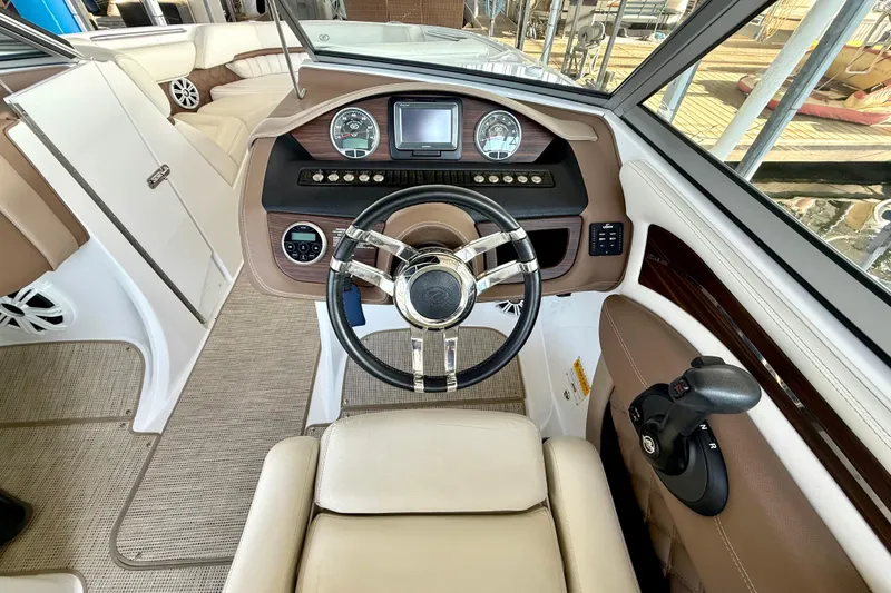 Slide: The Image of Interior view of 2013 Cobalt A25 boat cockpit with steering wheel and controls. - 31