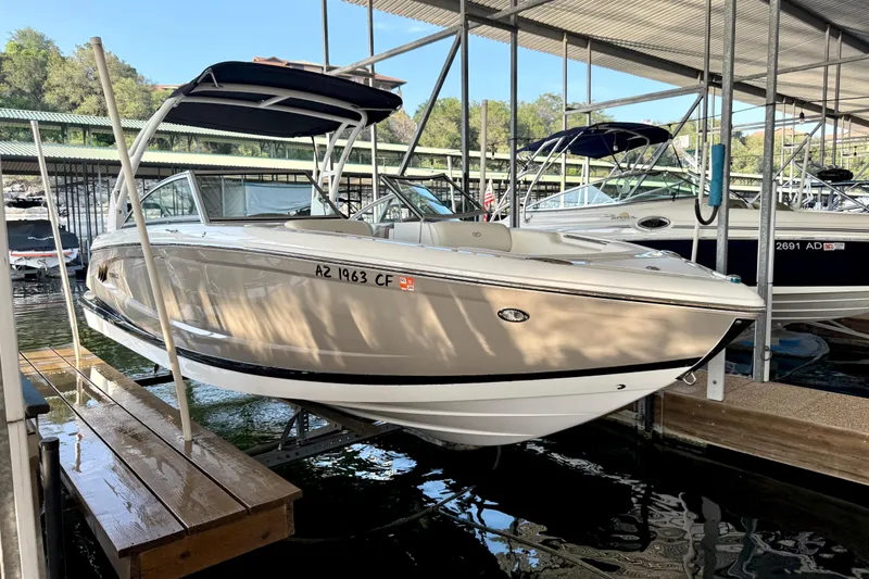 Slide: The Image of 2013 Cobalt A25 boat docked in a marina under a covered structure. - 36