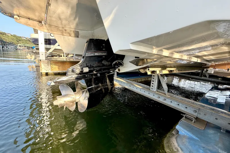 Slide: The Image of 2013 Cobalt A25 boat with MerCruiser outdrive on a lift at a marina. - 38