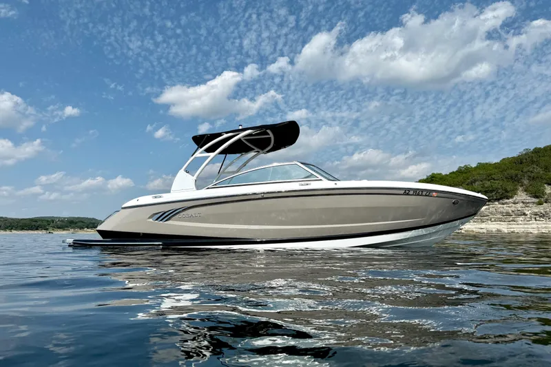 Slide: The Image of 2013 Cobalt A25 boat on calm water under a partly cloudy sky. - 4