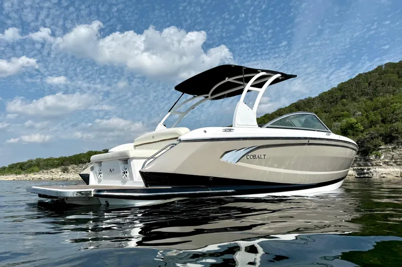 Slide: The Image of 2013 Cobalt A25 boat on water with scenic background and blue sky. - 6