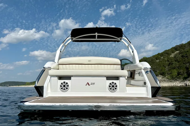 Slide: The Image of 2013 Cobalt A25 boat on water, featuring sleek design and luxurious seating. - 7