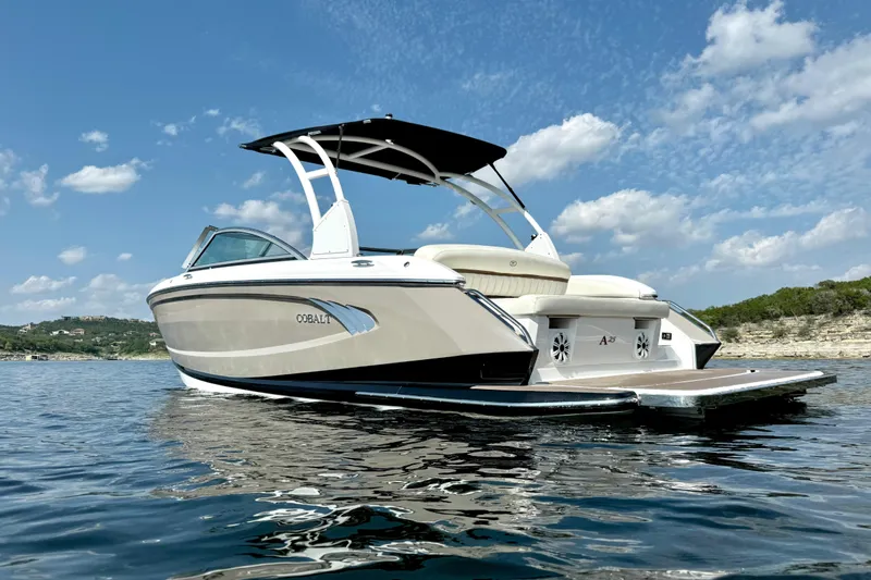 Slide: The Image of 2013 Cobalt A25 boat on water under blue sky with clouds. - 8