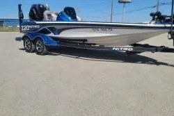 Slide: The Image of 2019 Nitro Z20 Pro boat on trailer, parked outdoors under clear blue sky. - 13
