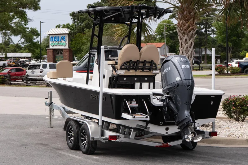 Slide: The Image of 2026 Sea Pro 230 Bay boat with Yamaha 200 engine on trailer, parked near Neuse Sport Shop. - 4