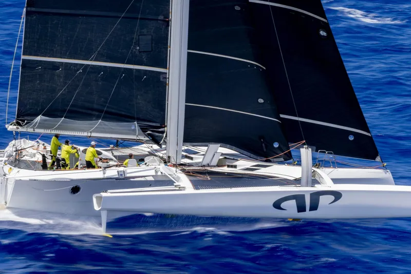 The Image of Sailing yacht CDK Technologies MOD 70, 2012 model, gliding on vibrant blue ocean waters. - 0