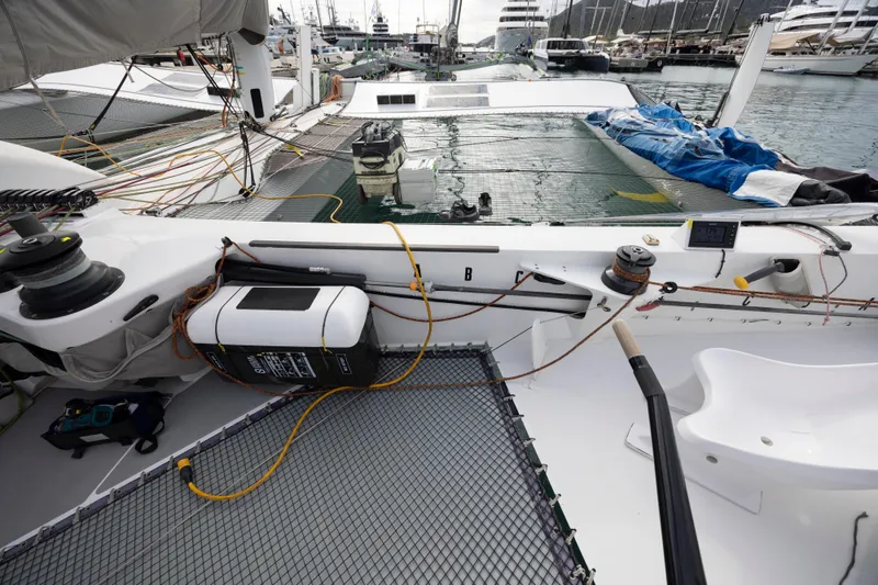 Slide: The Image of Sailing yacht deck of 2012 CDK Technologies MOD 70, featuring ropes and equipment. - 14