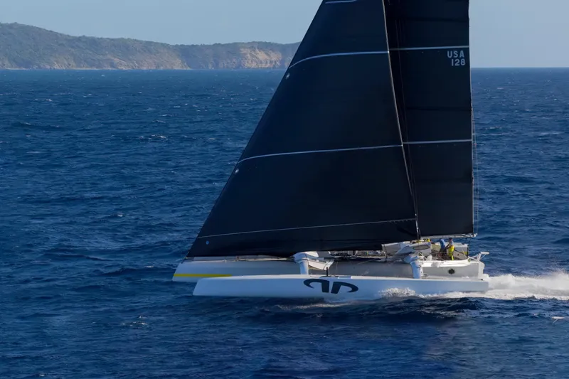 Slide: The Image of Sailing yacht CDK Technologies MOD 70, 2012, gliding on open sea with black sails. - 3