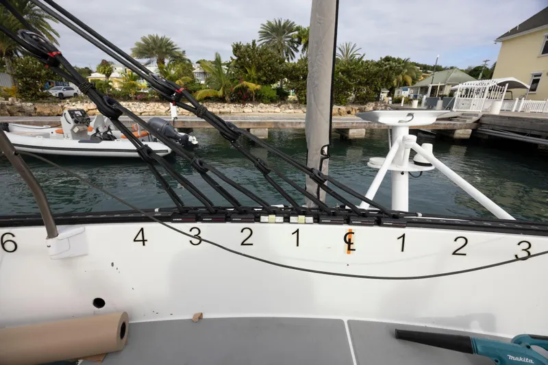 Slide: The Image of Sailing yacht deck with rigging, CDK Technologies MOD 70, 2012, docked near lush greenery. - 30