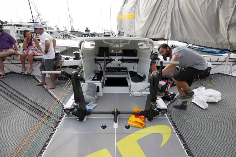 Slide: The Image of People on a 2012 CDK Technologies MOD 70 sailboat, docked at a marina. - 31