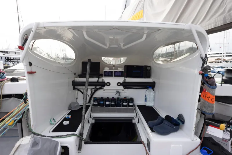 Slide: The Image of Cockpit of 2012 CDK Technologies MOD 70 sailboat with navigation equipment and storage. - 32