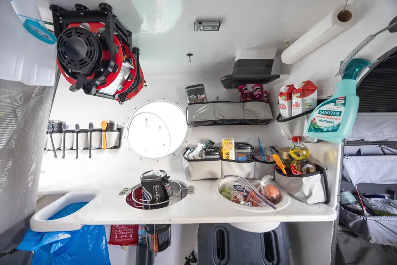 Slide: The Image of Compact kitchen area inside a 2012 CDK Technologies MOD 70, featuring organized storage and supplies. - 34