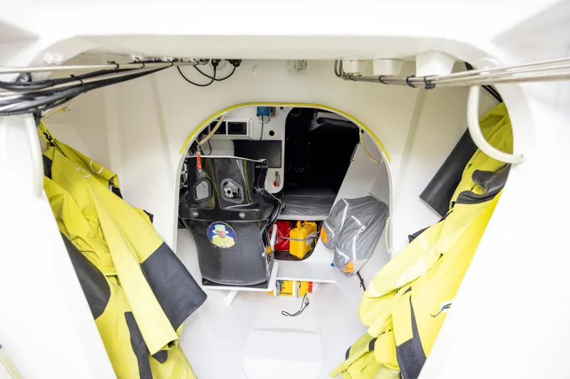 Slide: The Image of Interior of 2012 CDK Technologies MOD 70 sailboat, featuring gear and equipment storage. - 38