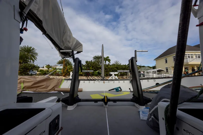 Slide: The Image of View from CDK Technologies MOD 70 sailboat, docked near tropical landscape and residential area. - 44