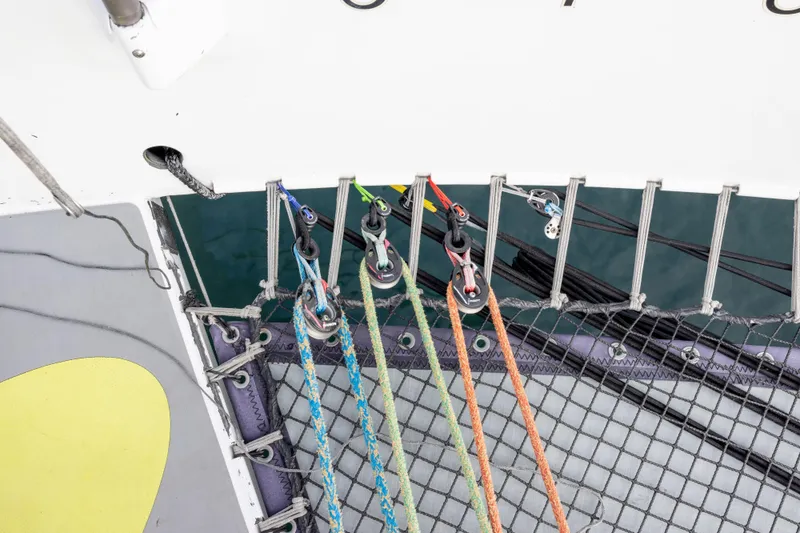 Slide: The Image of Ropes and netting on a 2012 CDK Technologies MOD 70 sailboat deck. - 45