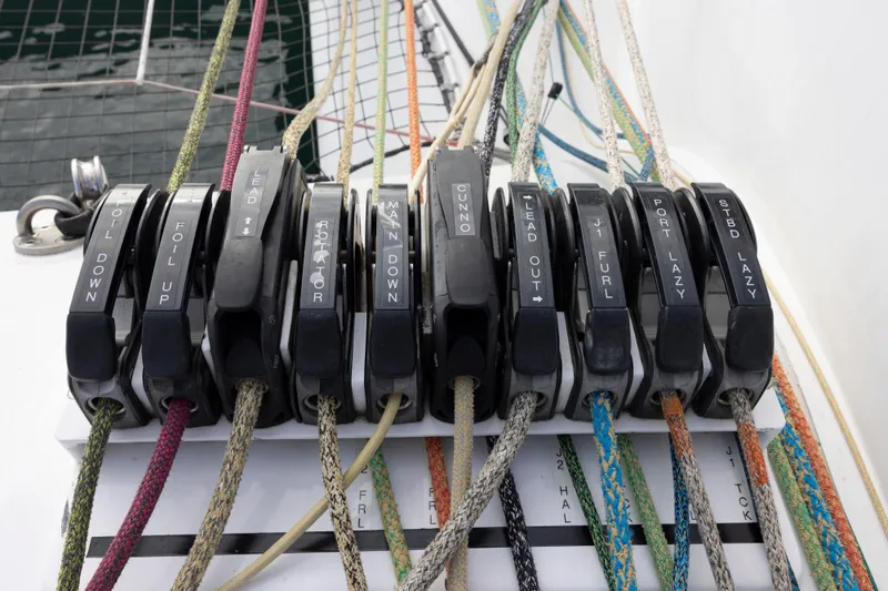 Slide: The Image of Control panel with labeled ropes on a 2012 CDK Technologies MOD 70 sailboat. - 47