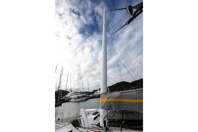 Slide: The Image of Sailboat mast of 2012 CDK Technologies MOD 70 at marina under cloudy sky. - 55