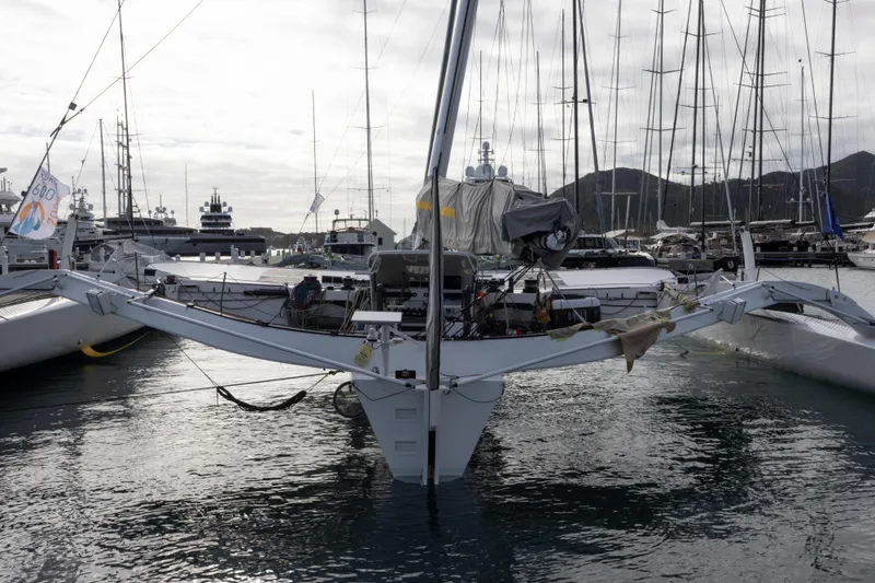 Slide: The Image of Trimaran sailboat CDK Technologies MOD 70, 2012 model, docked in a marina with other yachts. - 57