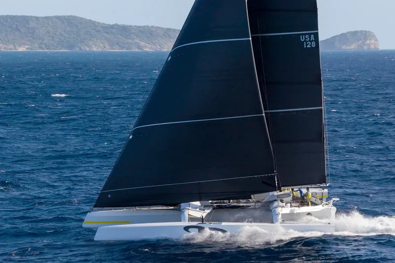 Slide: The Image of Sailing yacht CDK Technologies MOD 70, 2012, gliding on open sea with black sails. - 62