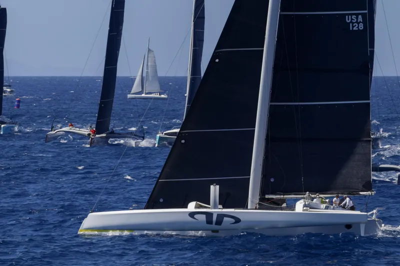Slide: The Image of Sailing race featuring 2012 CDK Technologies MOD 70 trimarans on open sea. - 65