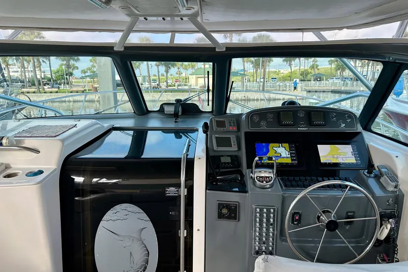 Slide: The Image of Interior view of a 2004 Pursuit 3800 Express boat cockpit with navigation equipment. - 11