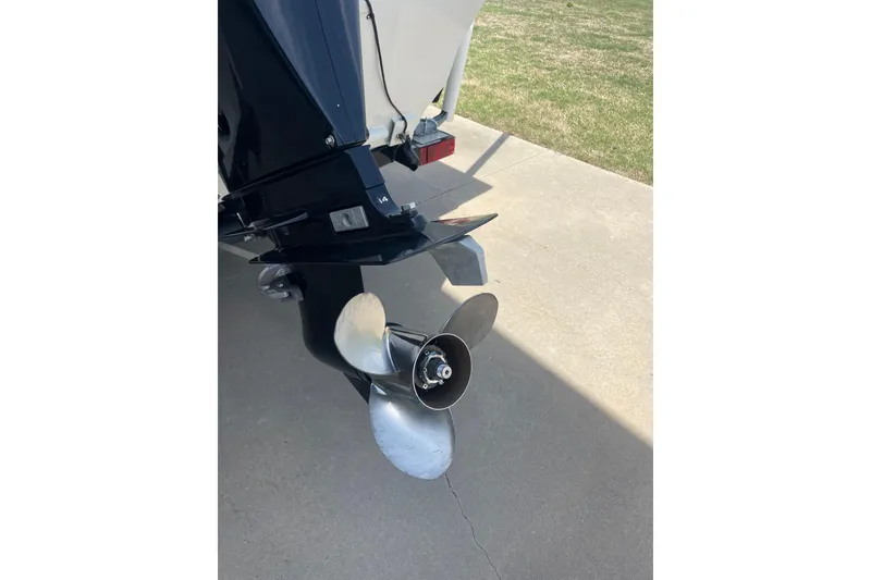 Slide: The Image of 2018 Tracker Pro Team 190 TX boat propeller on concrete driveway. - 4